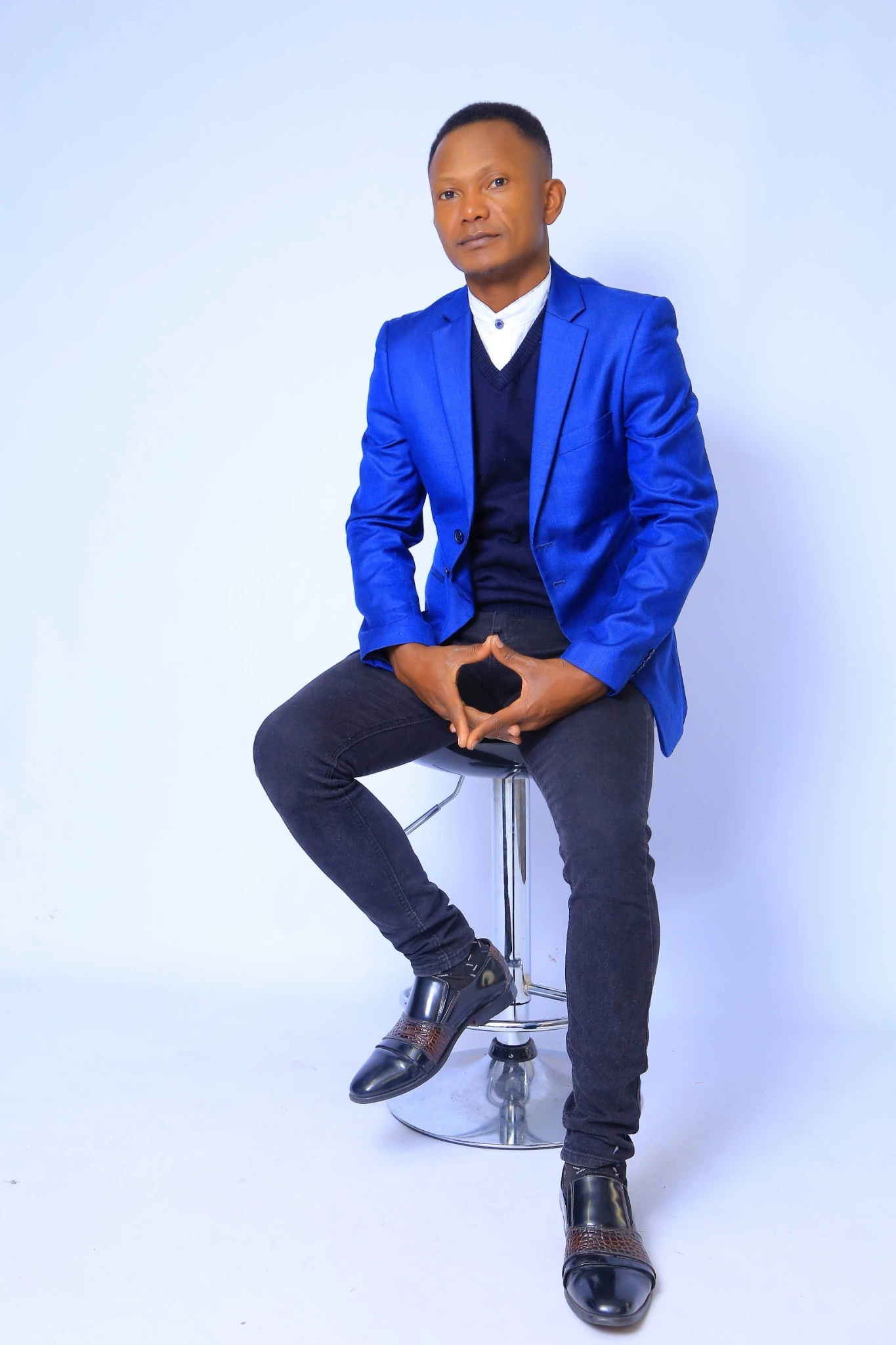 Sonny Bernaud Tchaka, seated in a royal-blue blazer.